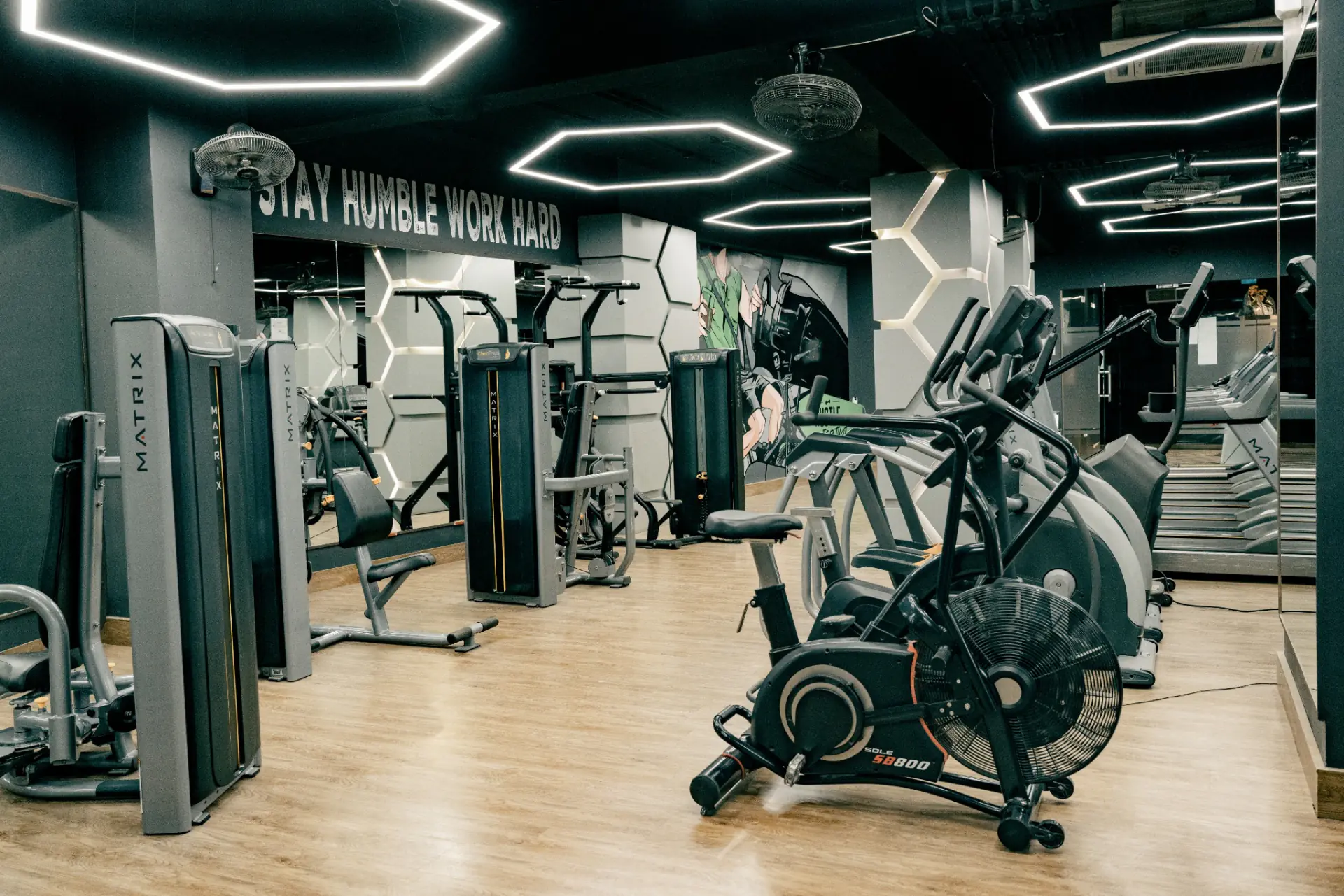 Bikes and machines on a quiet, well-lit training floor