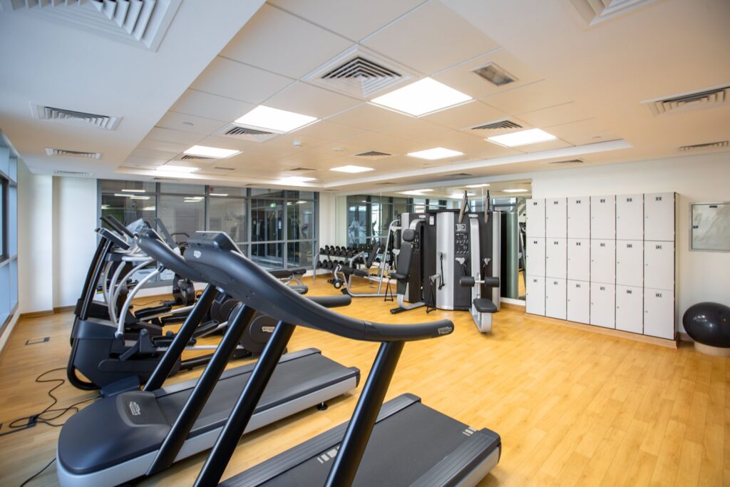 Empty gym with treadmills, dumbbell rack and strength machines