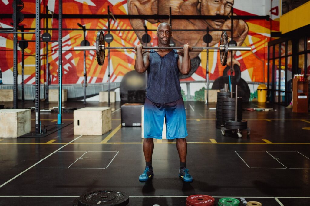 Man lifting a barbell in the gym for muscle building