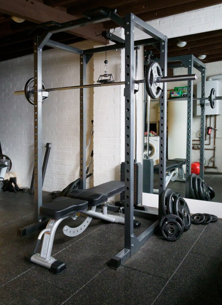 Empty gym power rack with barbell and weight bench