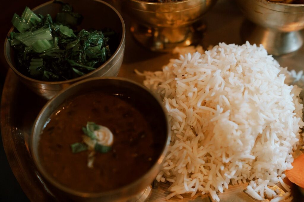Daal, rice and greens in a traditional desi meal