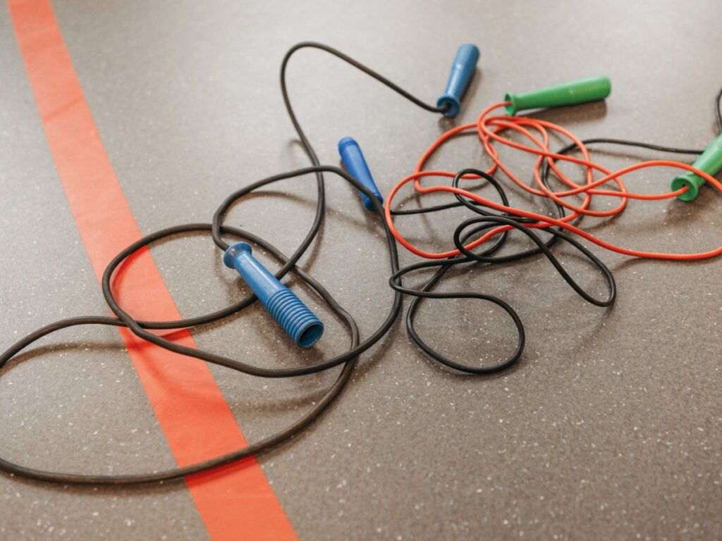 Jump ropes on a gym floor for stamina training.