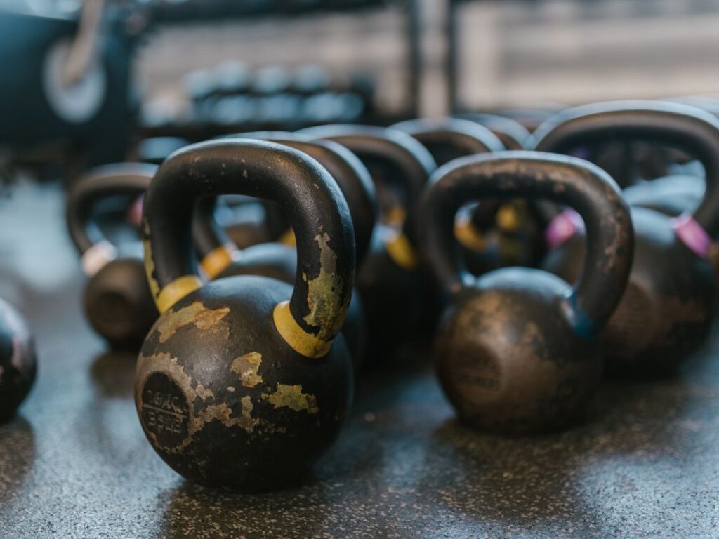 Row of black kettlebells on a gym floor