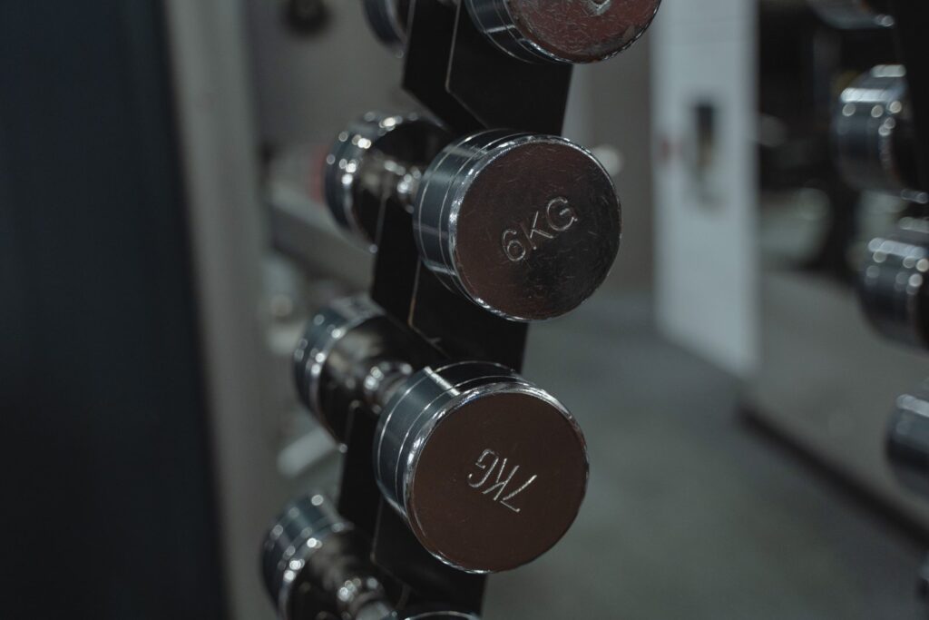 Chrome dumbbells on a gym rack